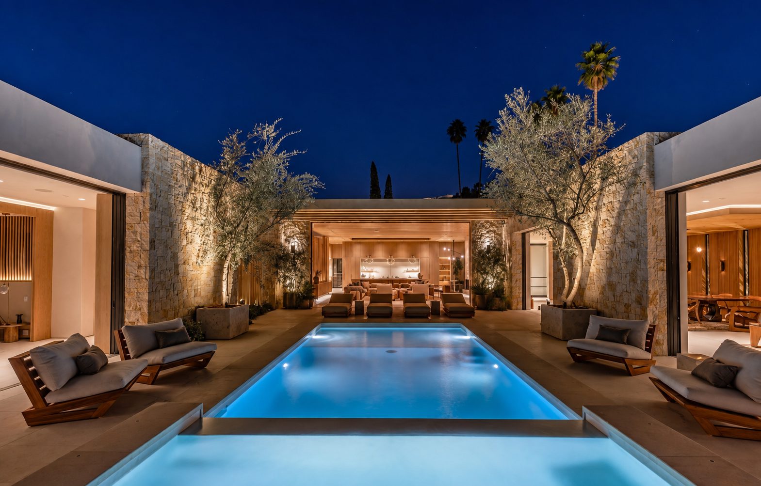 Full home remodel in Beverly Hills: courtyard, pool and open living space at dusk
